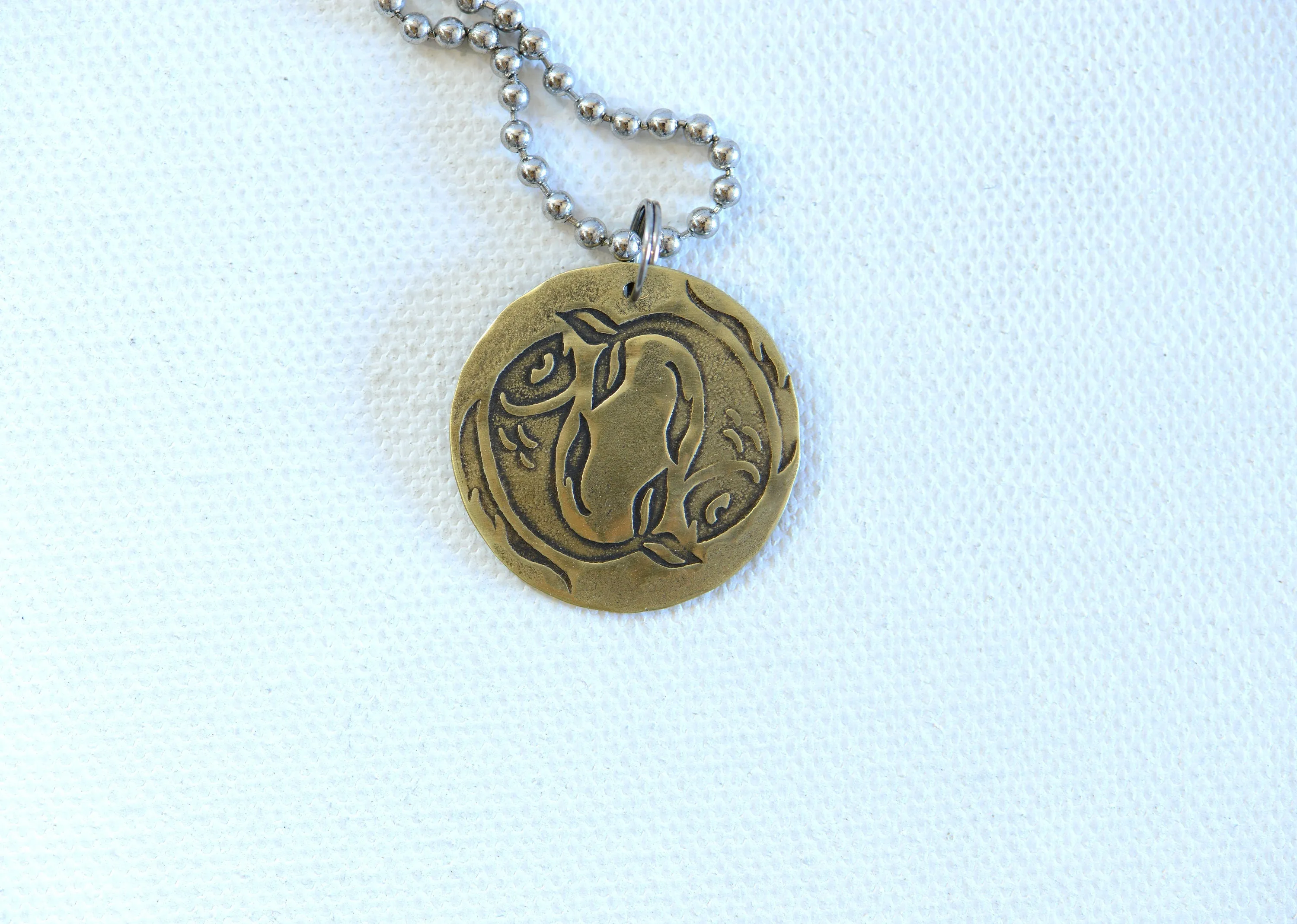 Zodiac charm style necklace shown with Pisces zodiac sign but can be personalized